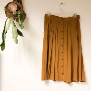 Mustard brown button down skirt. Good condition.